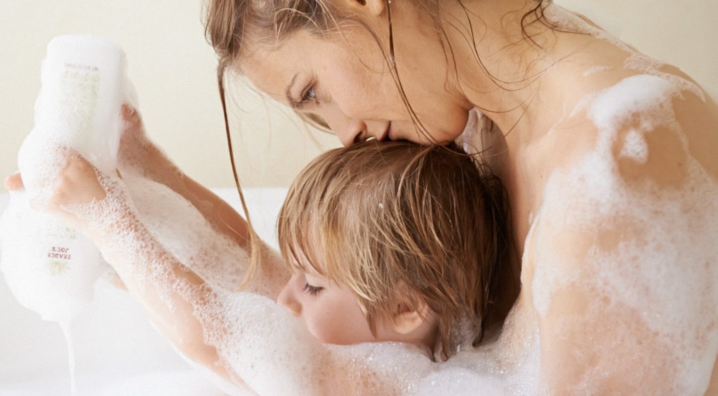 Alicia in bath with Bear.