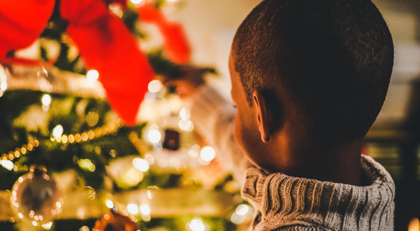 child at christmas tree